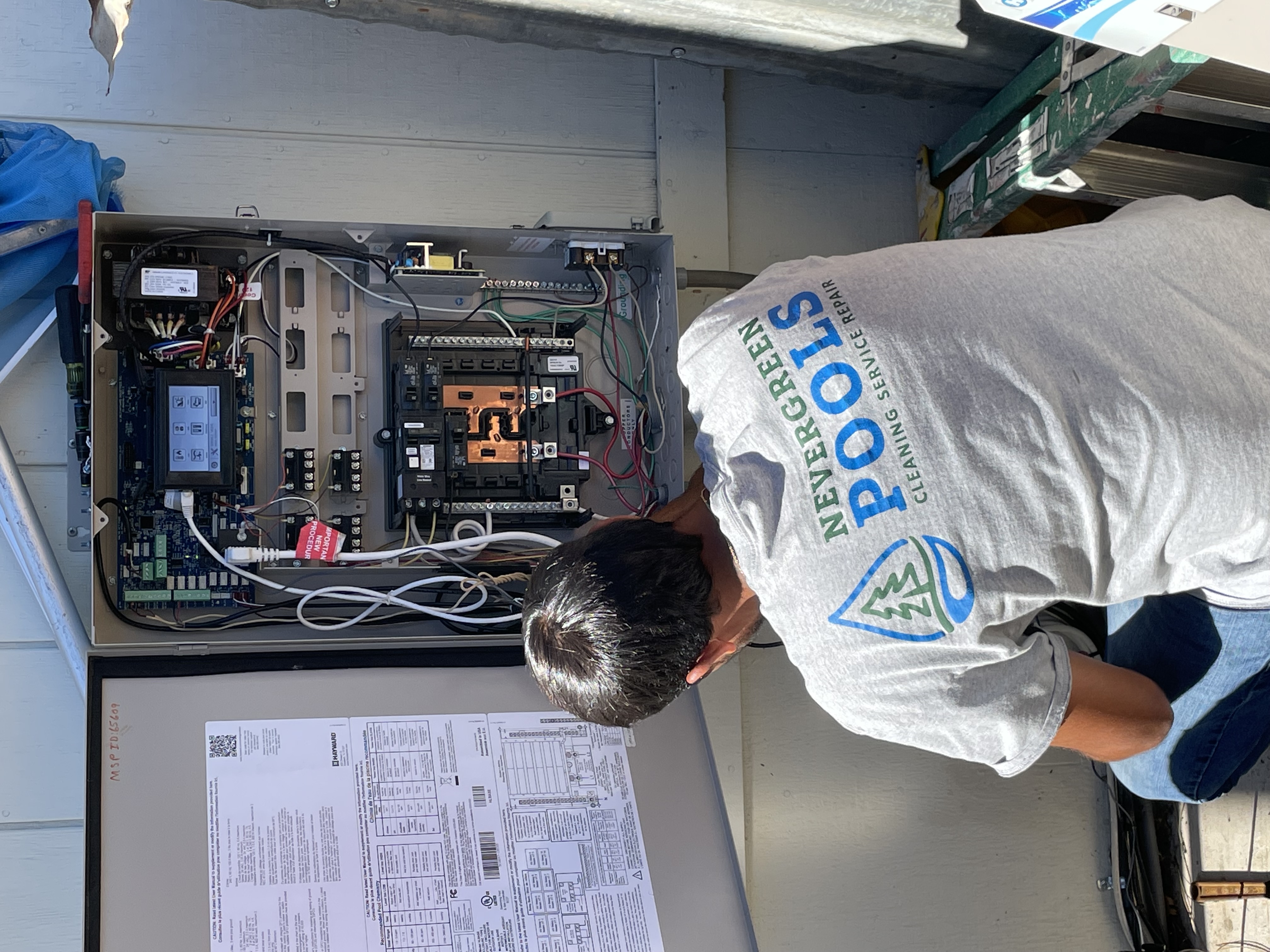 Vintage Pool Service tech inspecting pool equipment